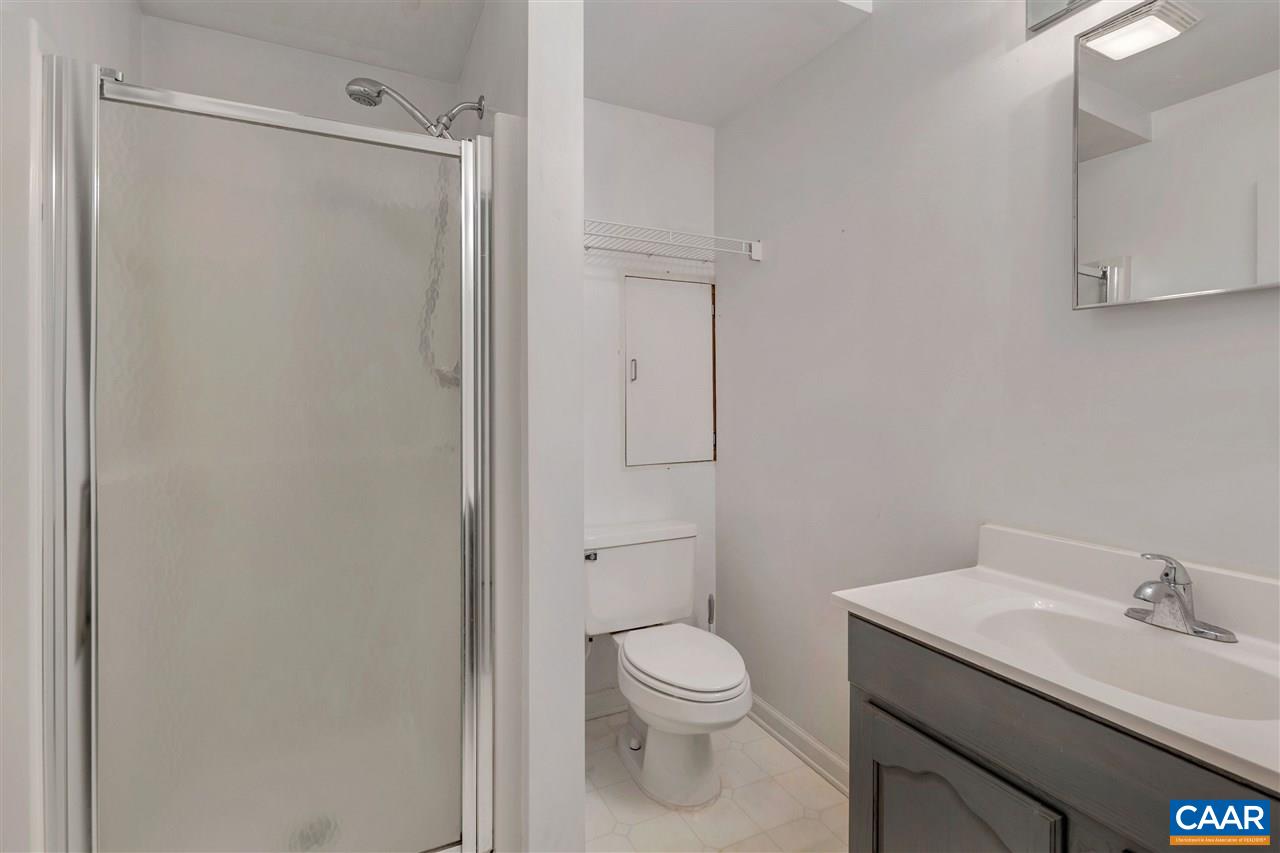 960 Claudius Court Crozet, VA 22932 - Photo 15 of 22 a bathroom with a granite countertop sink toilet and shower