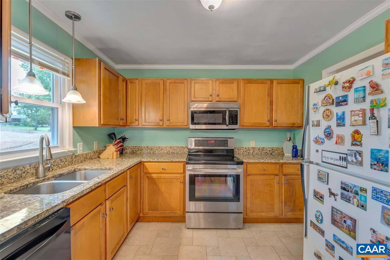 960 Claudius Court Crozet, VA 22932 - Photo 7 of 22 a kitchen with stainless steel appliances granite countertop a sink stove and microwave