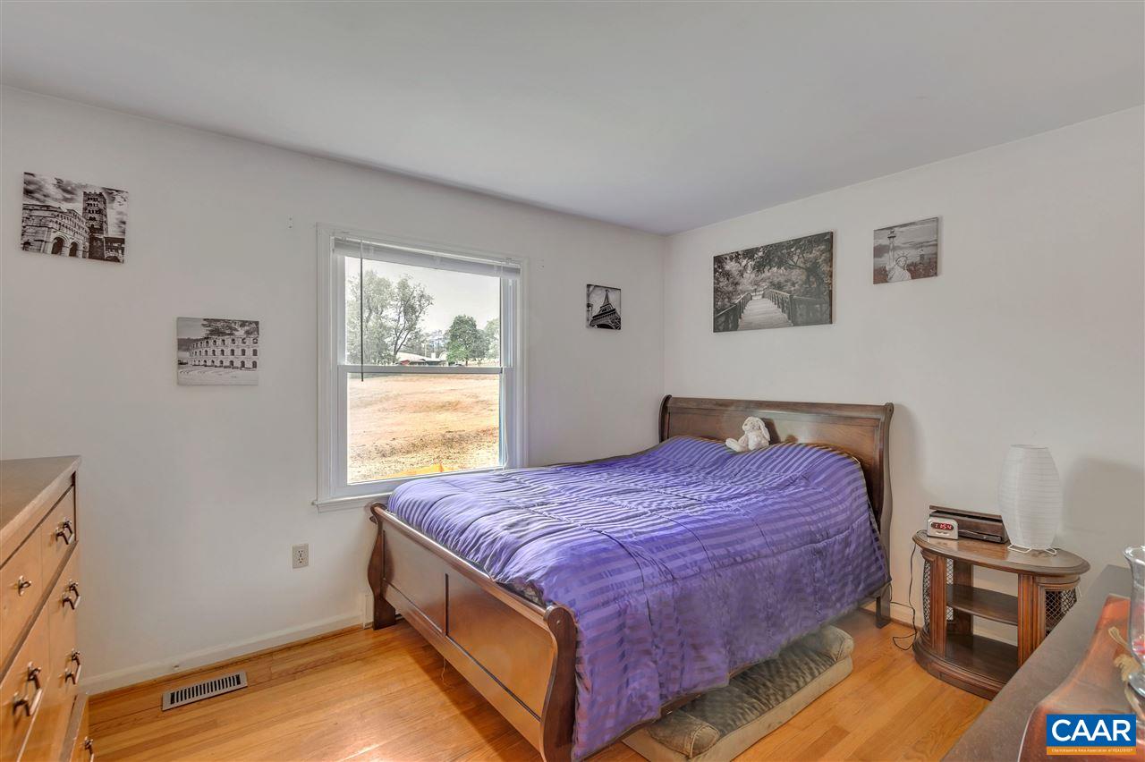 960 Claudius Court Crozet, VA 22932 - Photo 8 of 22 a spacious bedroom with a bed and wooden floor