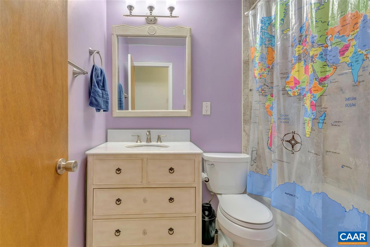 960 Claudius Court Crozet, VA 22932 - Photo 9 of 22 a bathroom with a sink a toilet and shower curtain