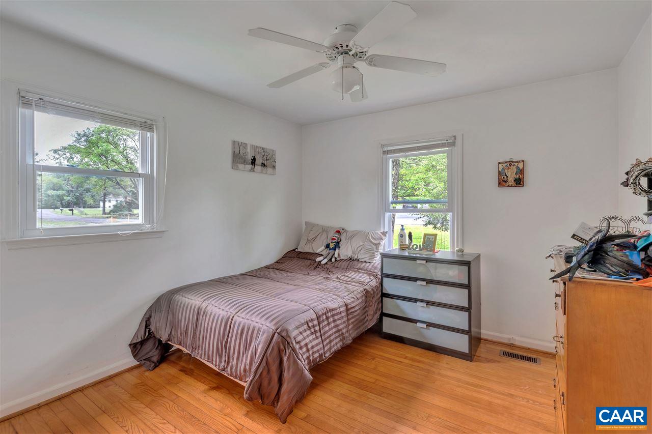 960 Claudius Court Crozet, VA 22932 - Photo 10 of 22 a bedroom with a bed a dresser and windows