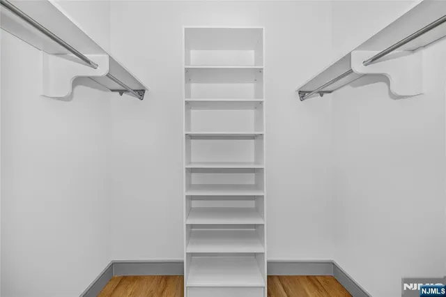 a view of walk in closet with empty racks