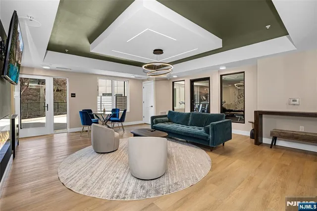 a living room with kitchen island furniture and a chandelier