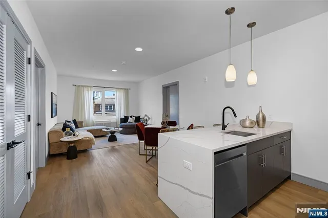 a view of living room with furniture and wooden floor