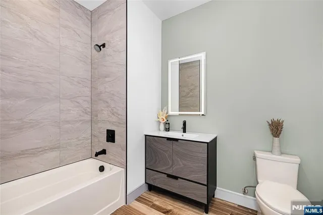 a bathroom with a toilet a sink and bathtub