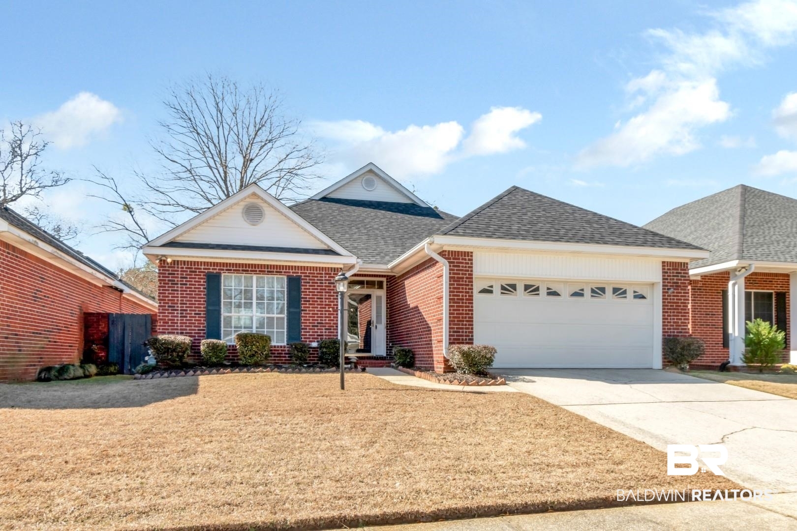 1032 Cross Gates Place Mobile, AL 36609 - Photo 33 of 34 Ranch-style house featuring a shingled roof, concrete driveway, brick siding, an attached garage, and a front yard