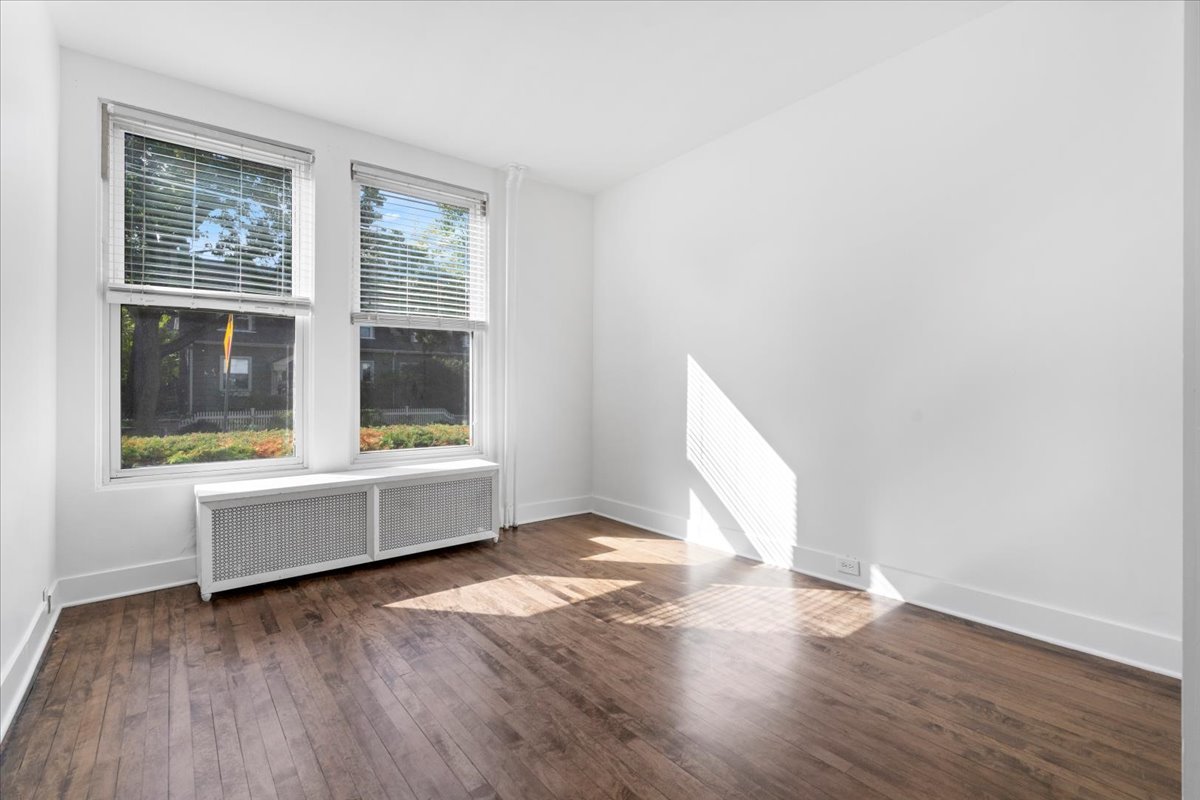 1097 Tower Road, Unit A Winnetka, IL 60093 - Photo 9 of 17 an empty room with wooden floor and windows