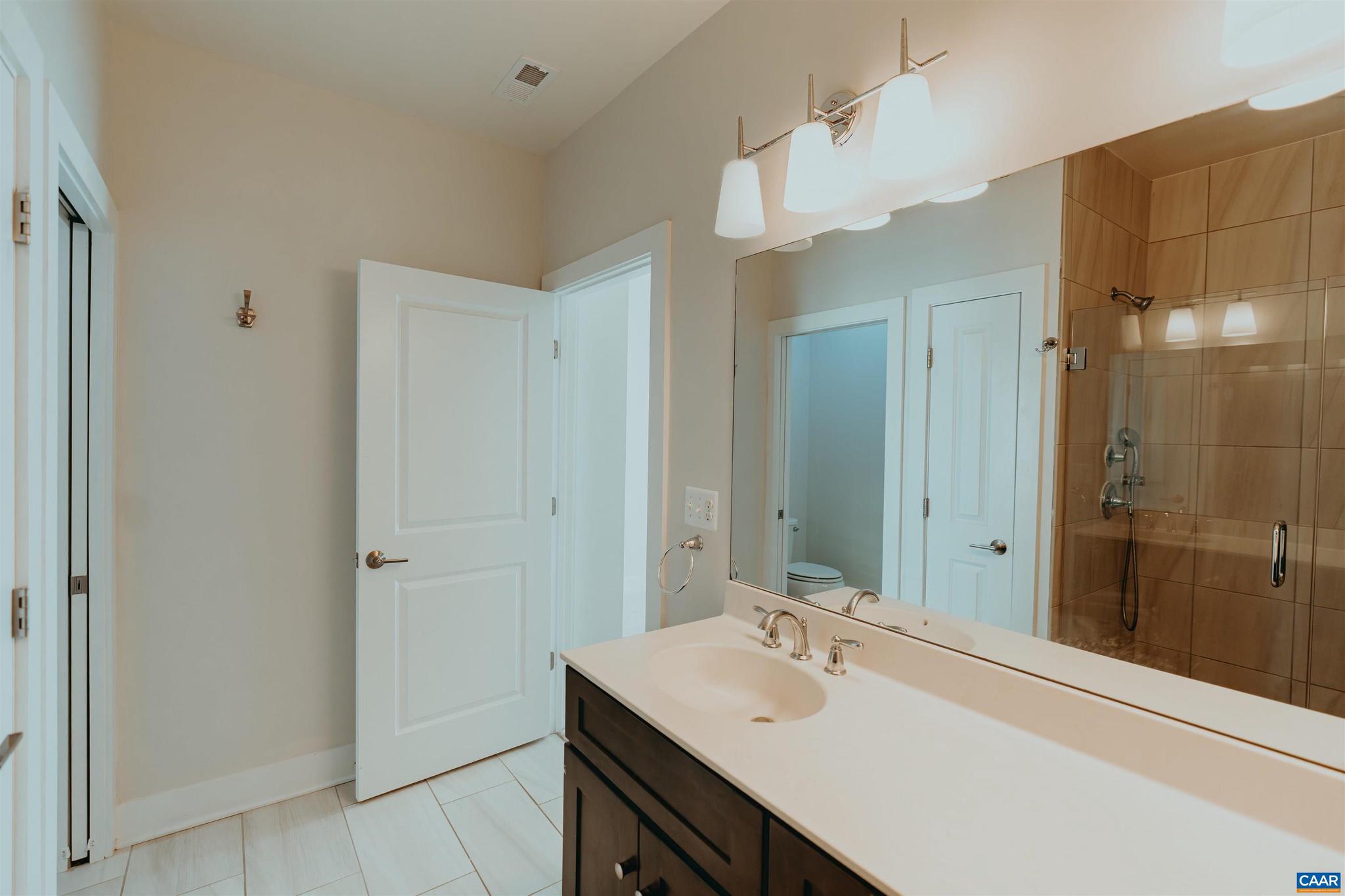 528 Trailside Drive Charlottesville, VA 22911 - Photo 30 of 51 a bathroom with a sink a shower and a mirror
