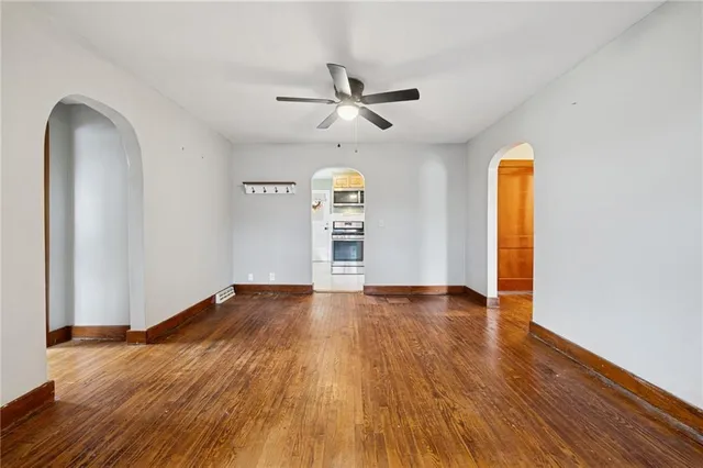 wooden floor in an empty room with a window
