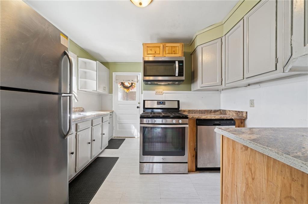 3425 Garvers Ferry Road New Kensington, PA 15068 - Photo 4 of 33 a kitchen with stainless steel appliances granite countertop a refrigerator a stove a sink and a microwave