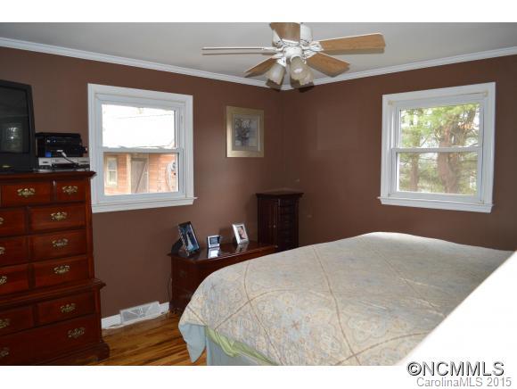329 Ridgedale Road Clyde, NC 28721 - Photo 12 of 22 a bedroom with a bed and a chandelier