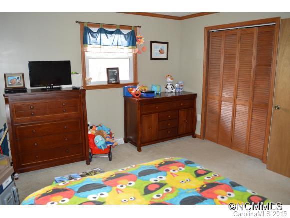 329 Ridgedale Road Clyde, NC 28721 - Photo 14 of 22 a bed room with a bed television and a window
