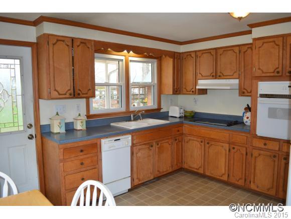 329 Ridgedale Road Clyde, NC 28721 - Photo 16 of 22 a kitchen with stainless steel appliances granite countertop a sink a stove and a refrigerator