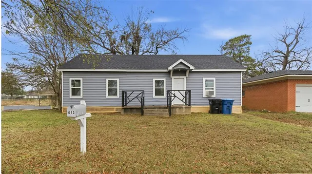 a house that has a tree in front of it