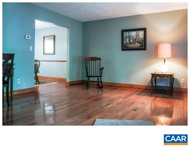 68 Amethyst Road Palmyra, VA 22963 - Photo 4 of 30 a room with a wooden floor and a chair