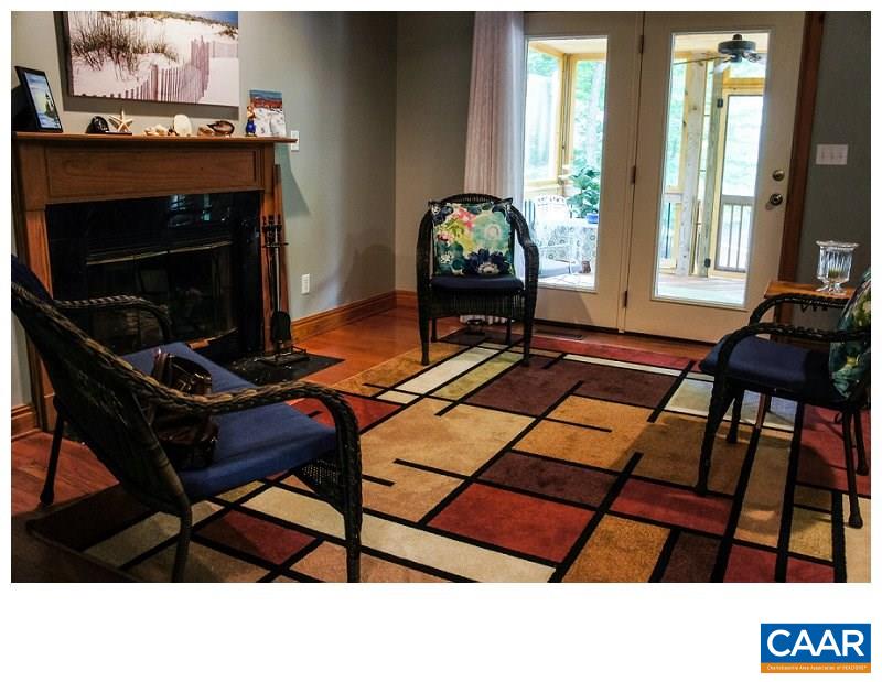 68 Amethyst Road Palmyra, VA 22963 - Photo 7 of 30 a living room with a fireplace a rug and a window