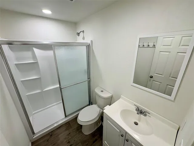 a bathroom with a sink toilet and shower