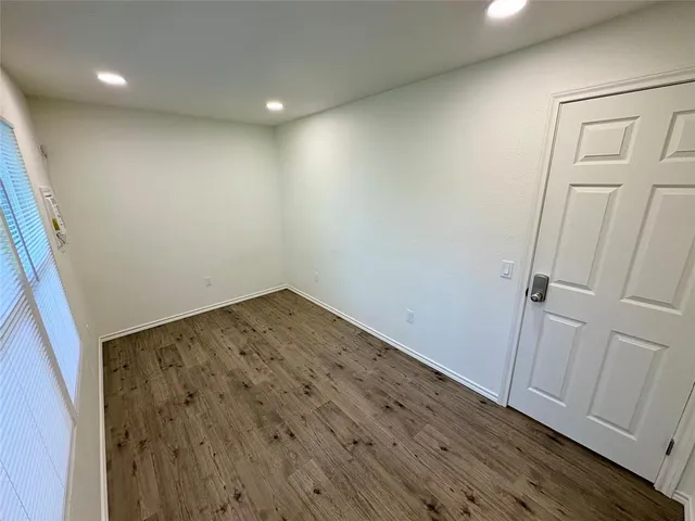 an empty room with wooden floor