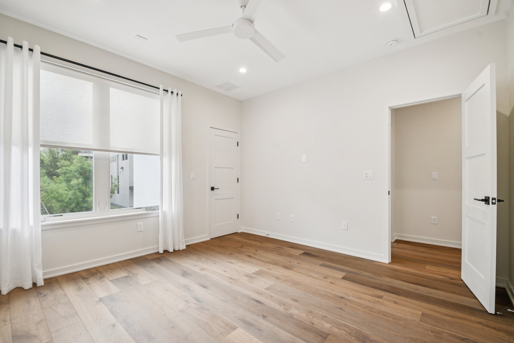 2518 Watkins Way Austin, TX 78746 - Photo 23 of 28 an empty room with wooden floor and windows