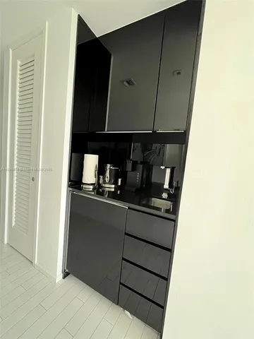 a kitchen with a refrigerator and cabinets