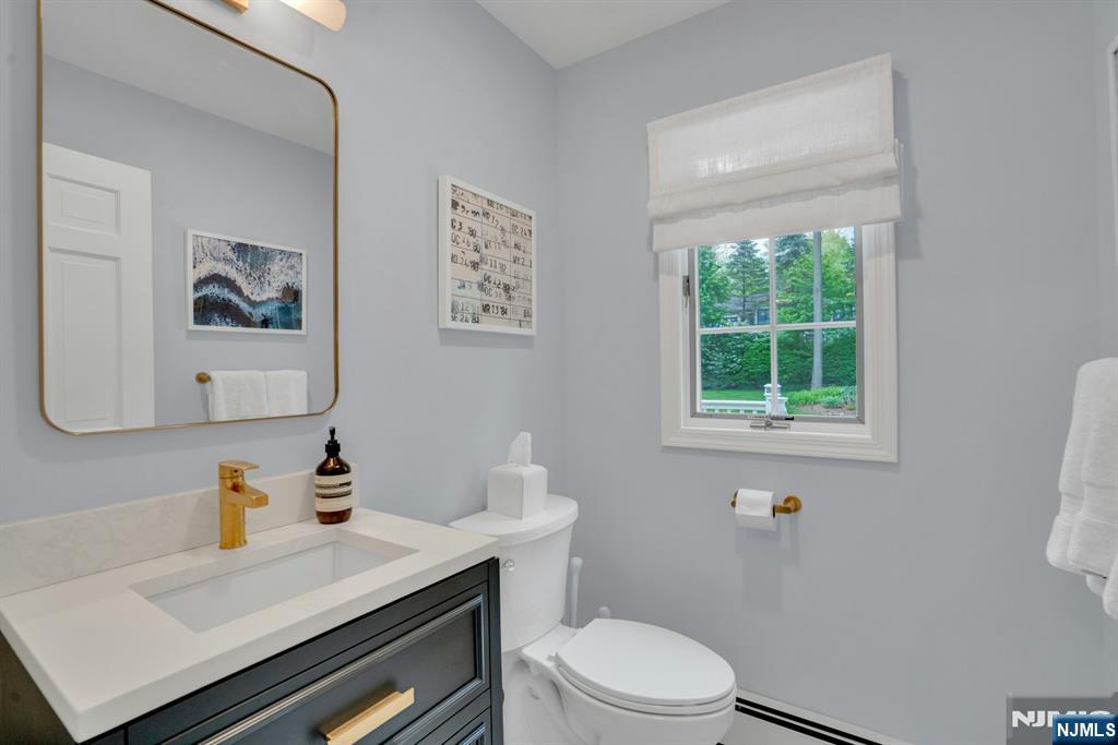 48 Hopper Farm Road Upper Saddle River, NJ 07458 - Photo 15 of 43 a bathroom with a sink a toilet and a window