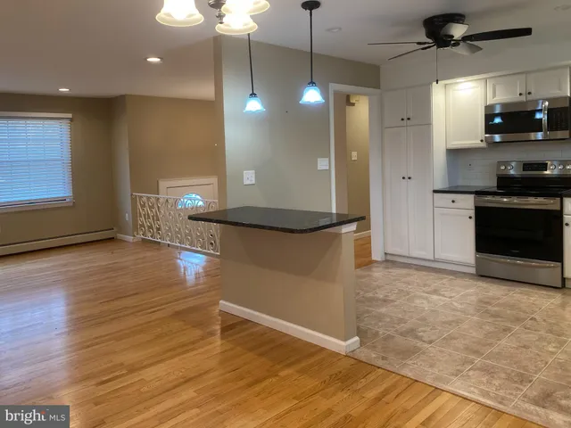 a view of a kitchen with a sink and a stove