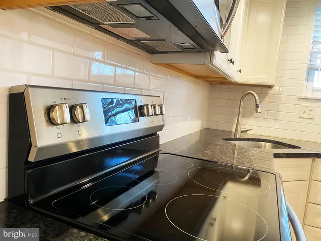 a kitchen with a stove and a sink