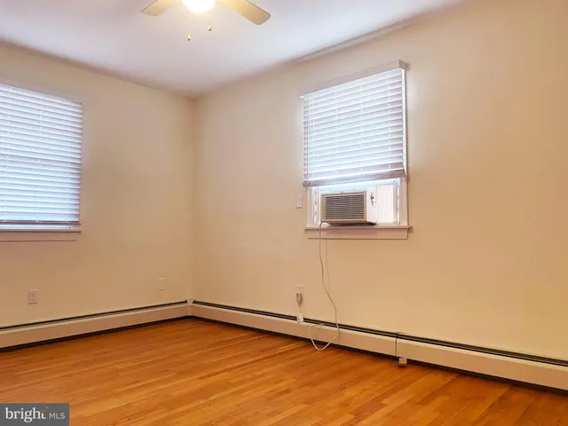 a view of a room with wooden floor and a window
