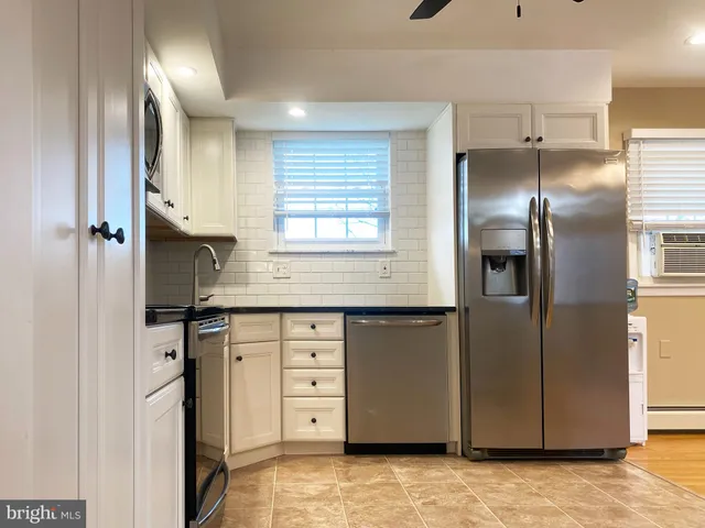 a kitchen with stainless steel appliances a refrigerator sink and cabinets