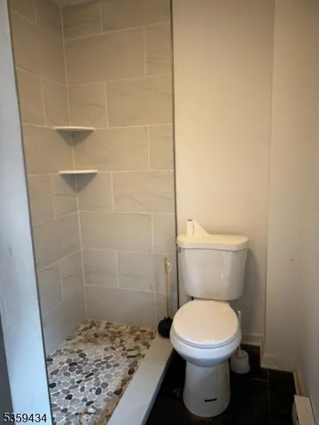 a bathroom with a toilet and a shower