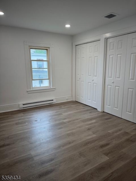 252 Spring Street Newton, NJ 07860 - Photo 7 of 18 an empty room with wooden floor and windows