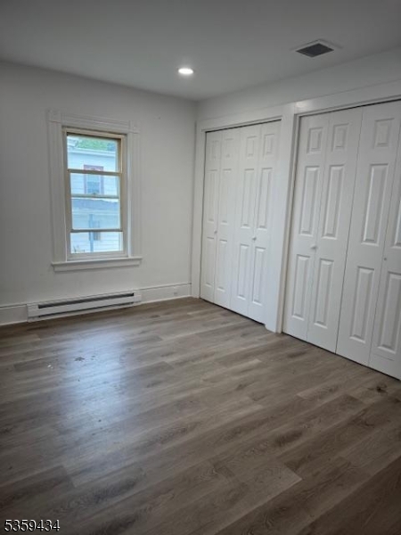 252 Spring Street Newton, NJ 07860 - Photo 8 of 18 an empty room with wooden floor and windows