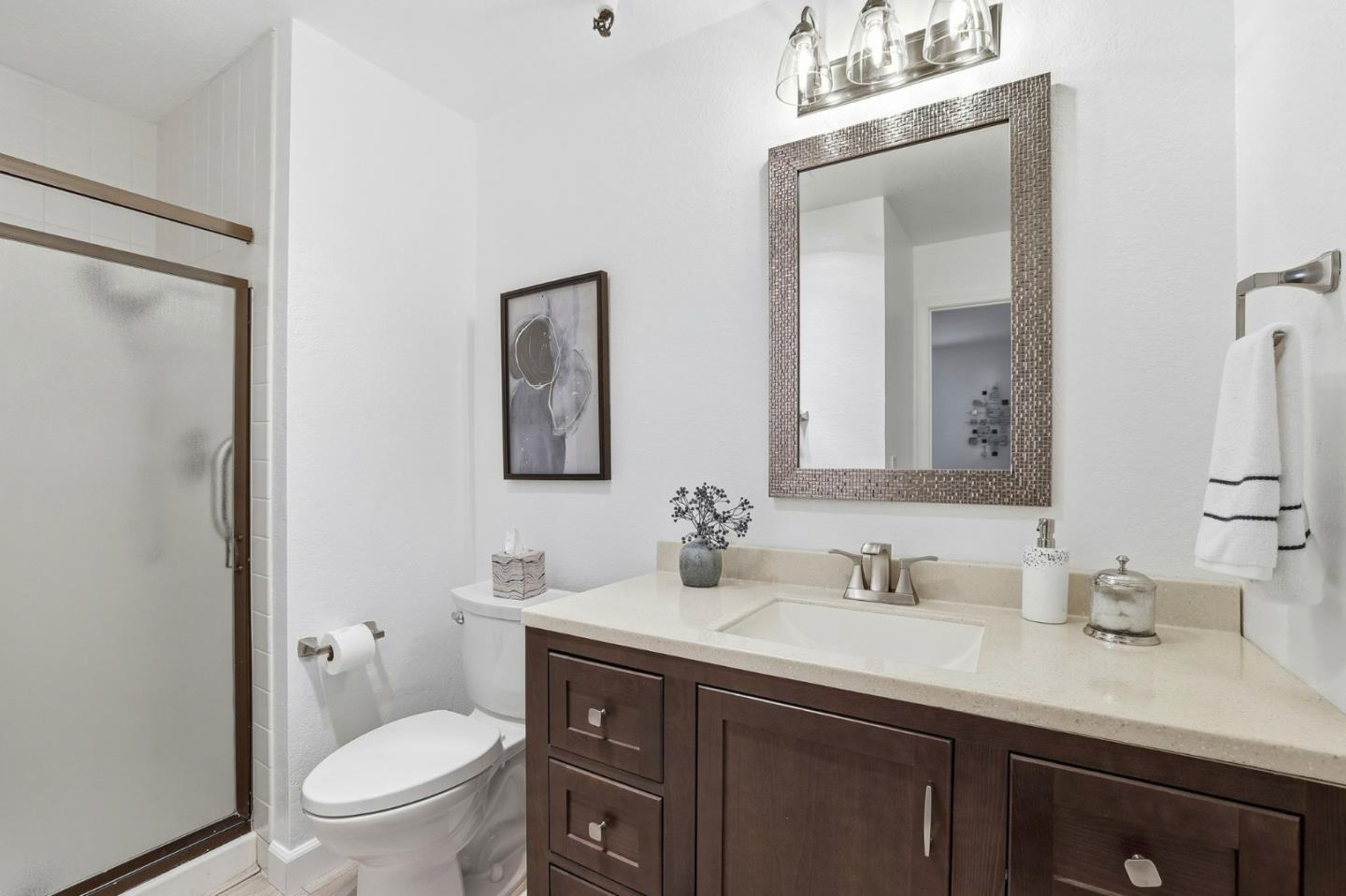 449 Alberto Way, Unit 132 Los Gatos, CA 95032 - Photo 19 of 42 a bathroom with a sink vanity granite toilet and a mirror