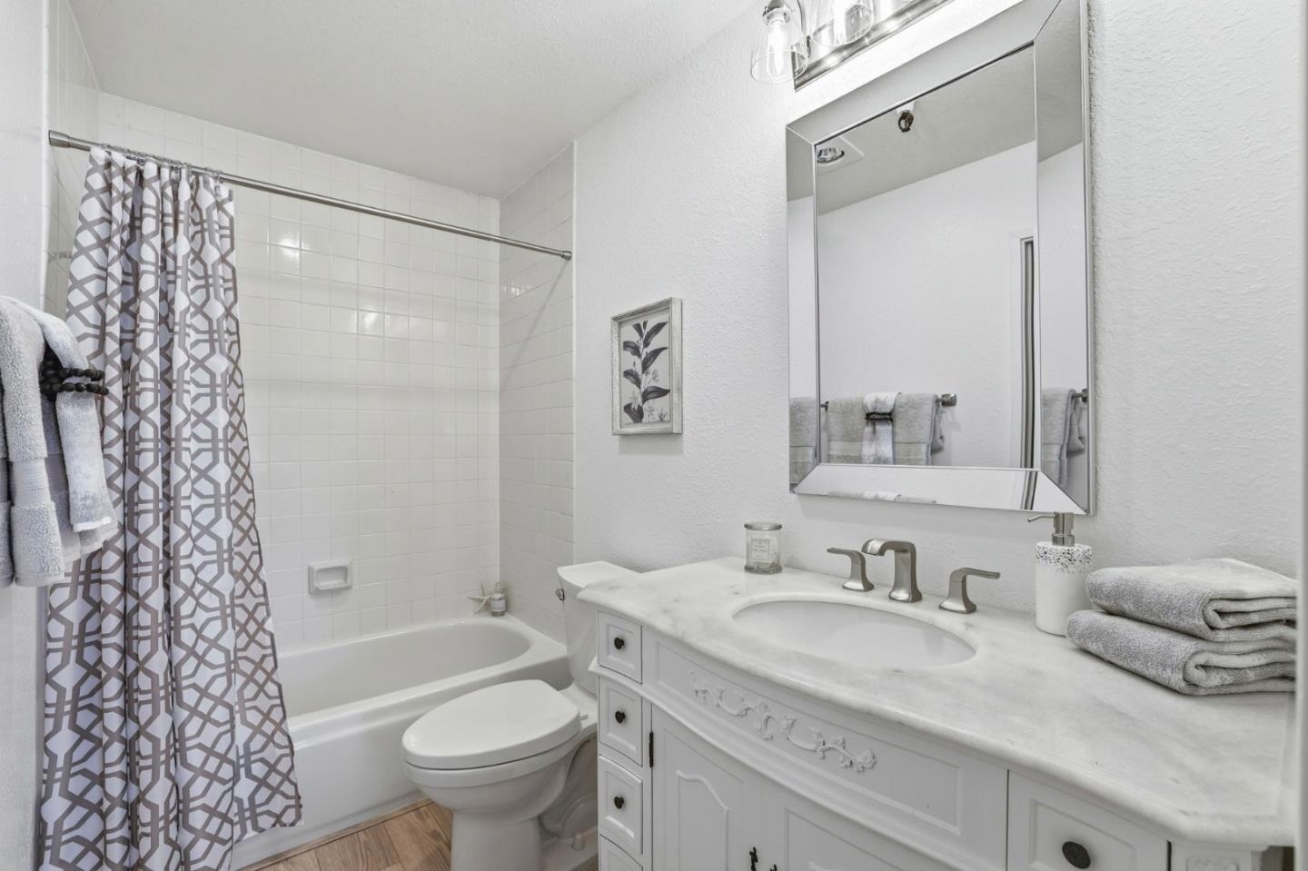 449 Alberto Way, Unit 132 Los Gatos, CA 95032 - Photo 20 of 42 a bathroom with a granite countertop sink toilet and shower