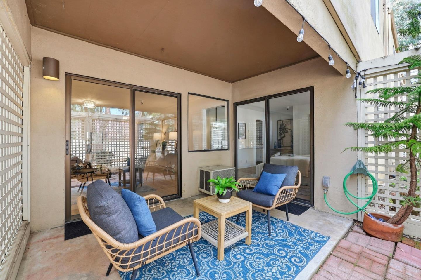 449 Alberto Way, Unit 132 Los Gatos, CA 95032 - Photo 24 of 42 a living room with furniture and a floor to ceiling window