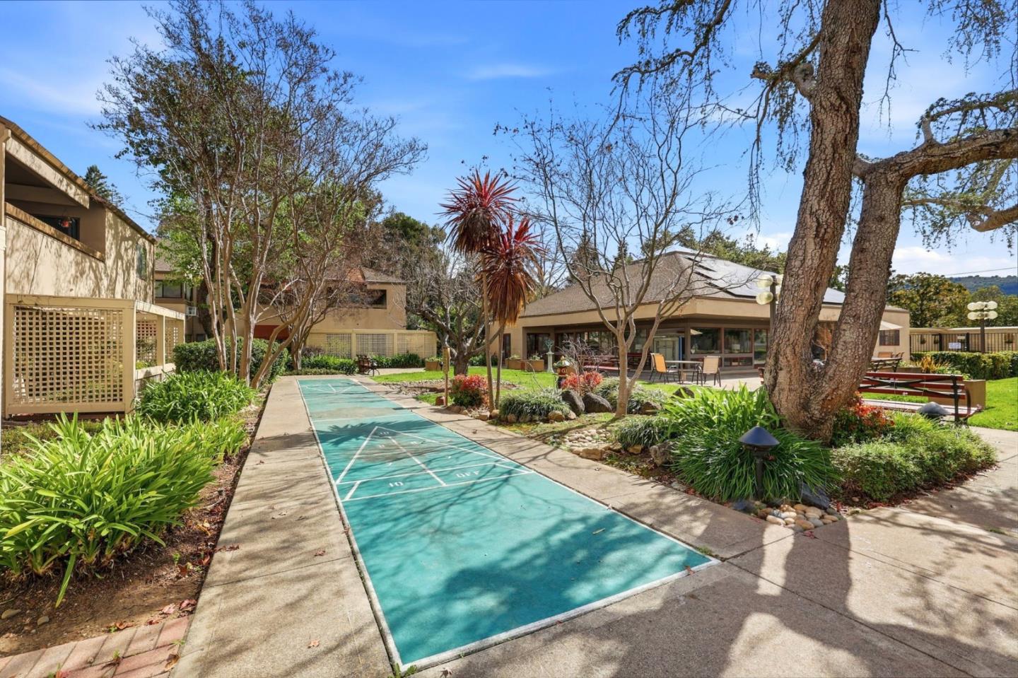 449 Alberto Way, Unit 132 Los Gatos, CA 95032 - Photo 34 of 42 a front view of a house with a yard and table and chairs