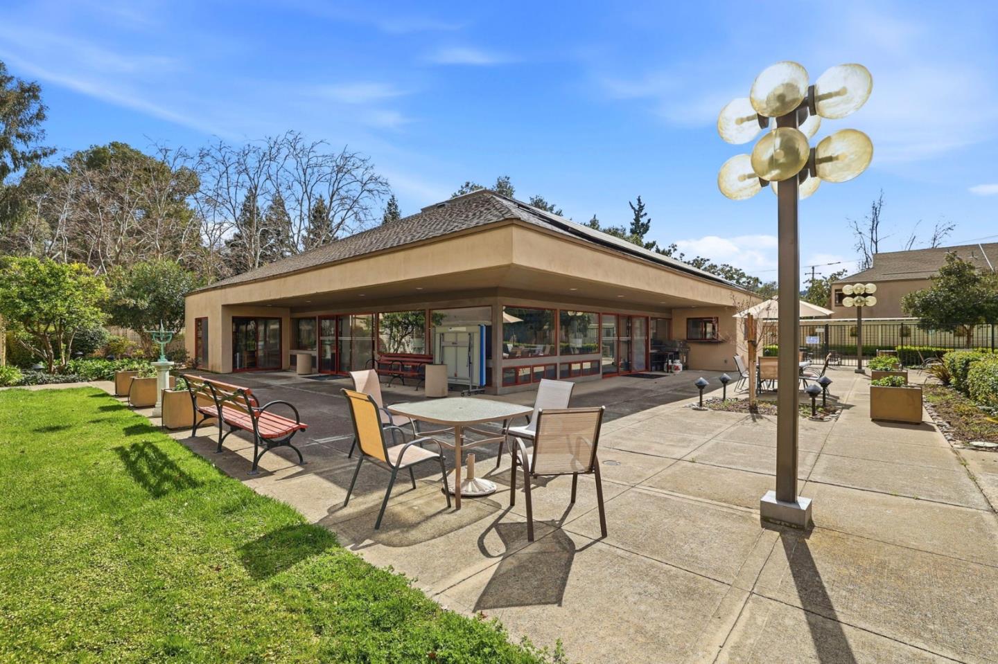 449 Alberto Way, Unit 132 Los Gatos, CA 95032 - Photo 36 of 42 a patio with a table and chairs and a fire pit