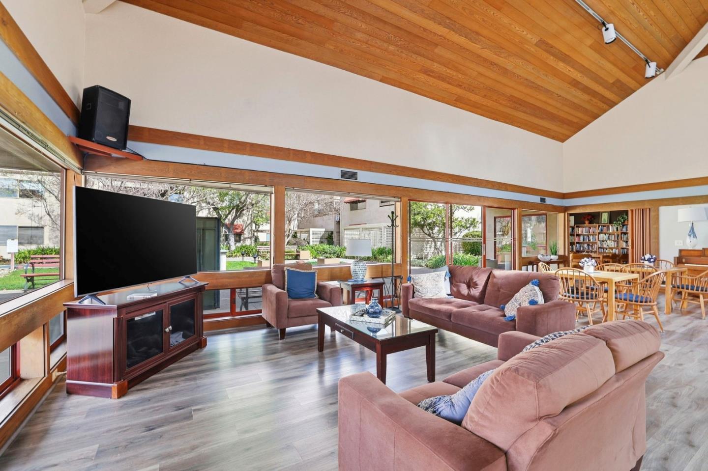 449 Alberto Way, Unit 132 Los Gatos, CA 95032 - Photo 38 of 42 a living room with furniture a flat screen tv and floor to ceiling window