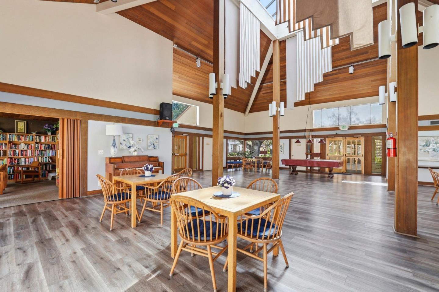 449 Alberto Way, Unit 132 Los Gatos, CA 95032 - Photo 39 of 42 a dining room with wooden floor table and chairs