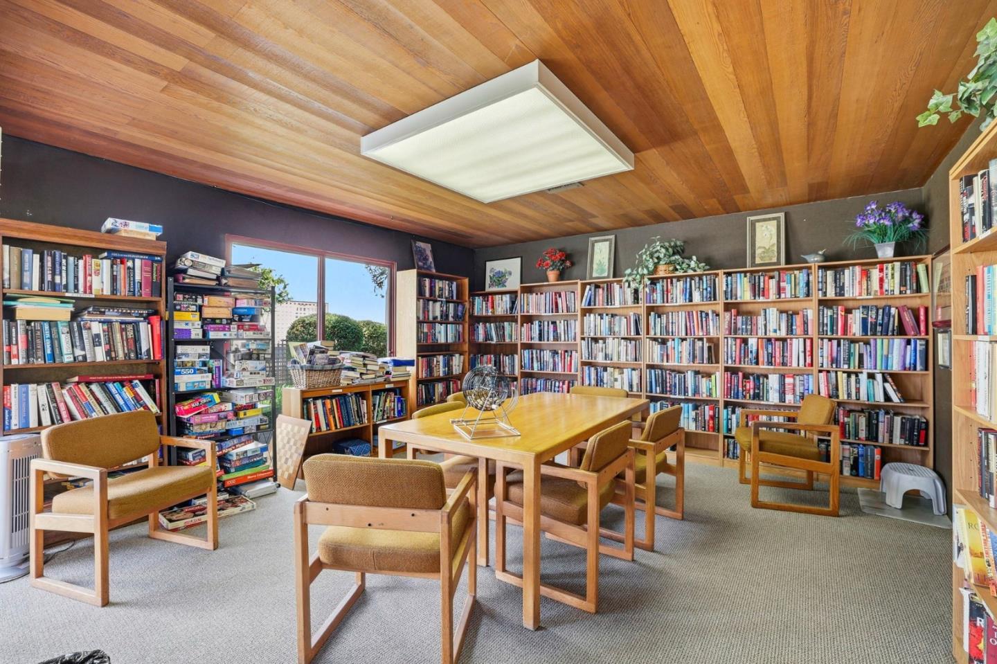 449 Alberto Way, Unit 132 Los Gatos, CA 95032 - Photo 41 of 42 a dining room with furniture and a book shelf