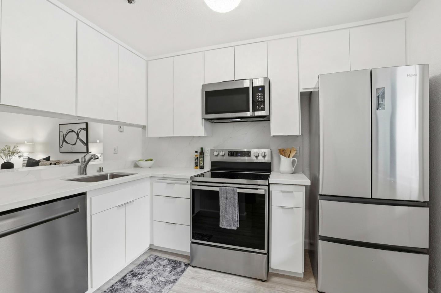 449 Alberto Way, Unit 132 Los Gatos, CA 95032 - Photo 8 of 42 a kitchen with stainless steel appliances a refrigerator stove and microwave