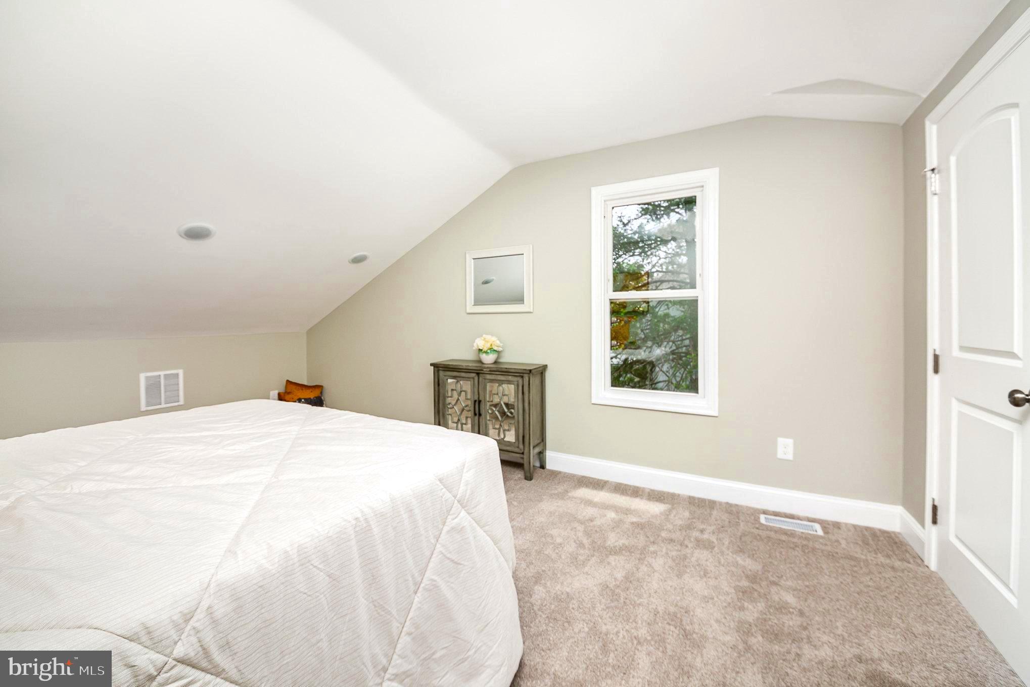 5611 Pilgrim Road Baltimore, MD 21214 - Photo 16 of 35 a spacious bedroom with a bed and a window