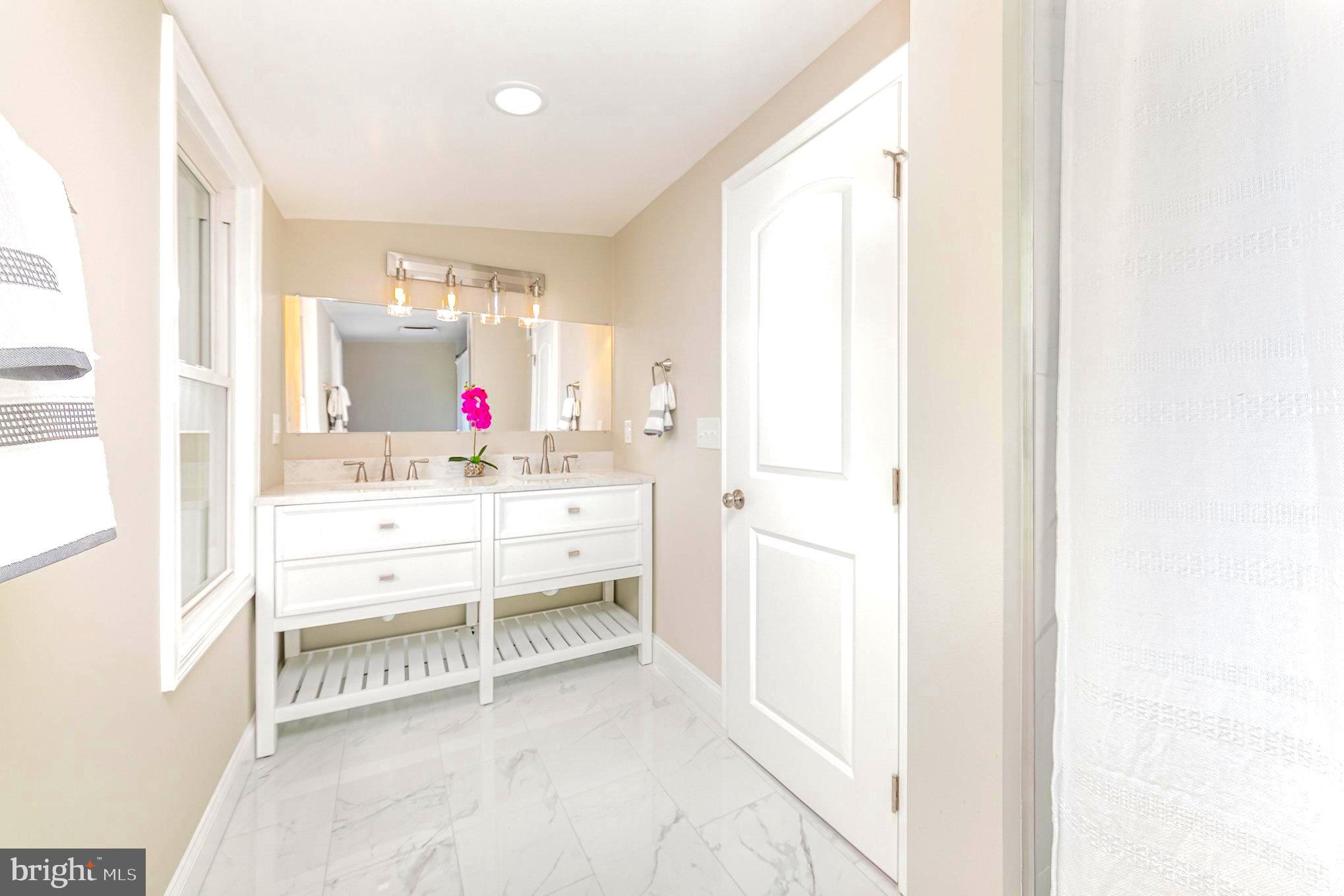 5611 Pilgrim Road Baltimore, MD 21214 - Photo 17 of 35 a room with a white furniture and window