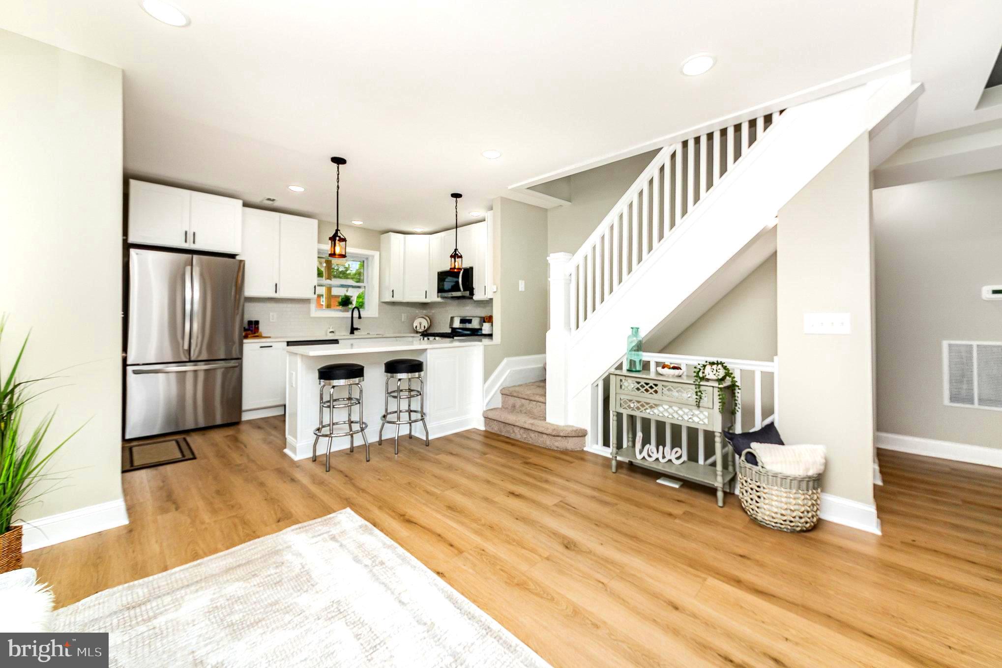 5611 Pilgrim Road Baltimore, MD 21214 - Photo 2 of 35 a kitchen with furniture a refrigerator and a view of living room