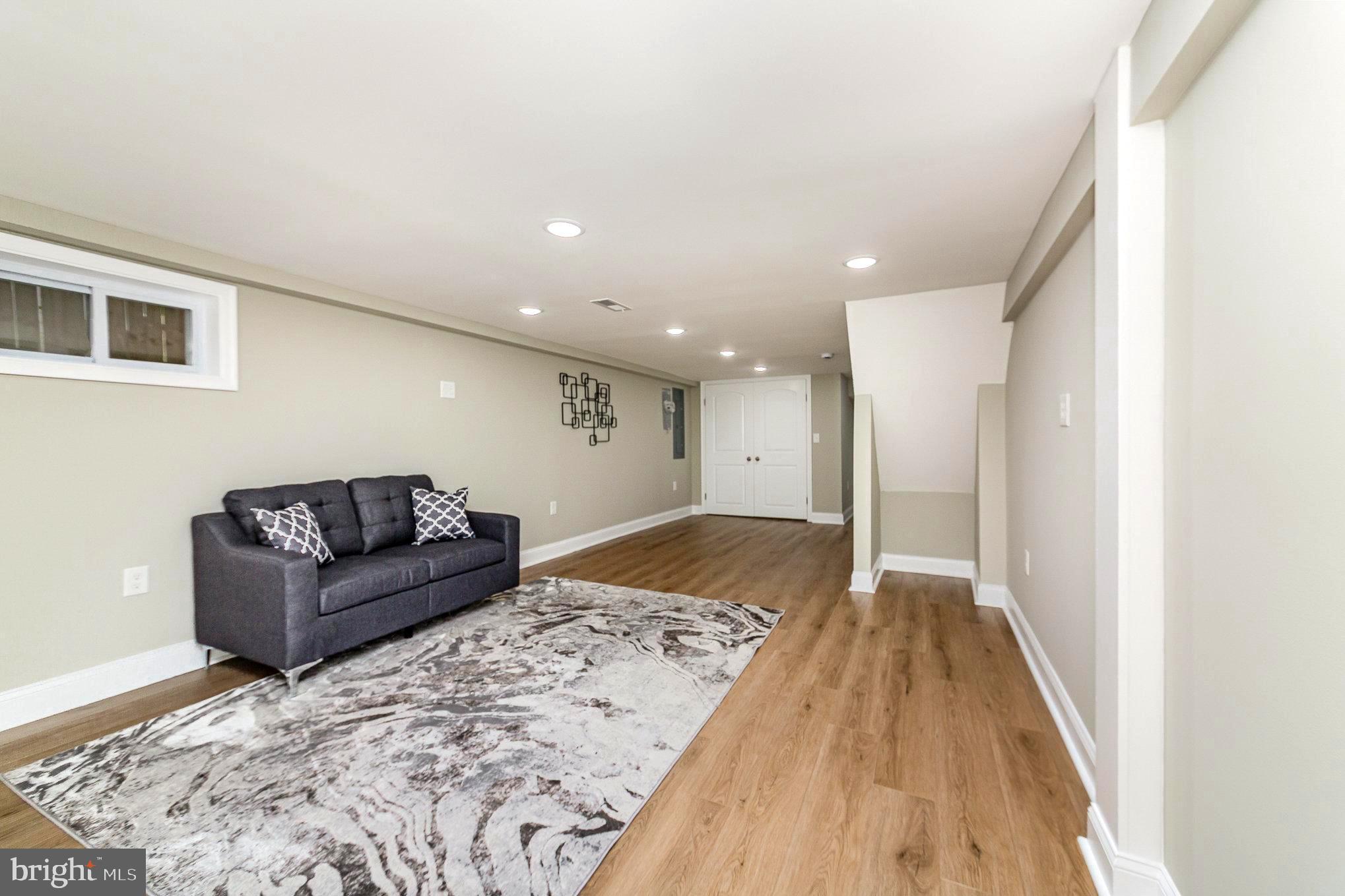 5611 Pilgrim Road Baltimore, MD 21214 - Photo 22 of 35 a living room with a couch and a dresser