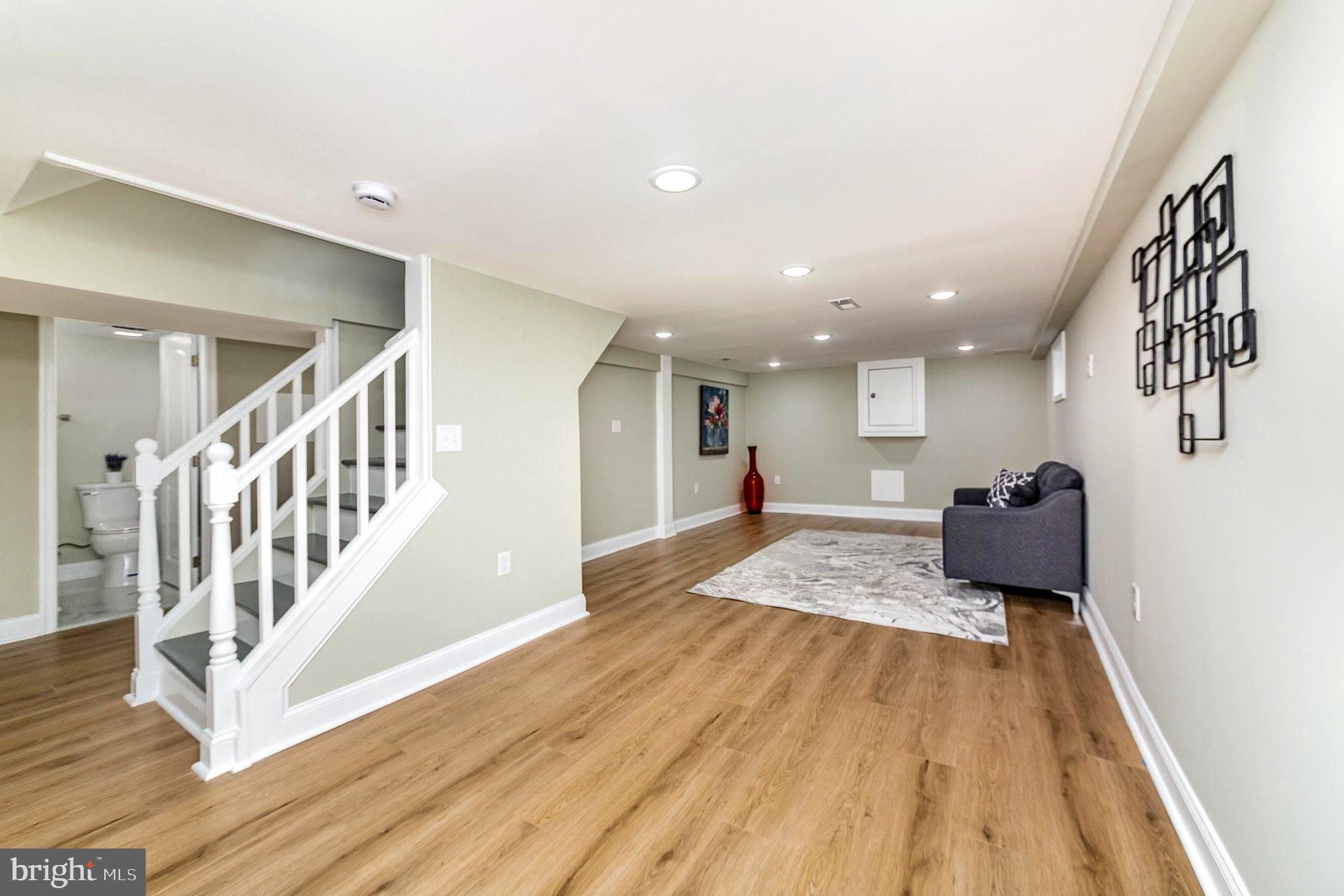5611 Pilgrim Road Baltimore, MD 21214 - Photo 23 of 35 a living room with furniture and a wooden floor
