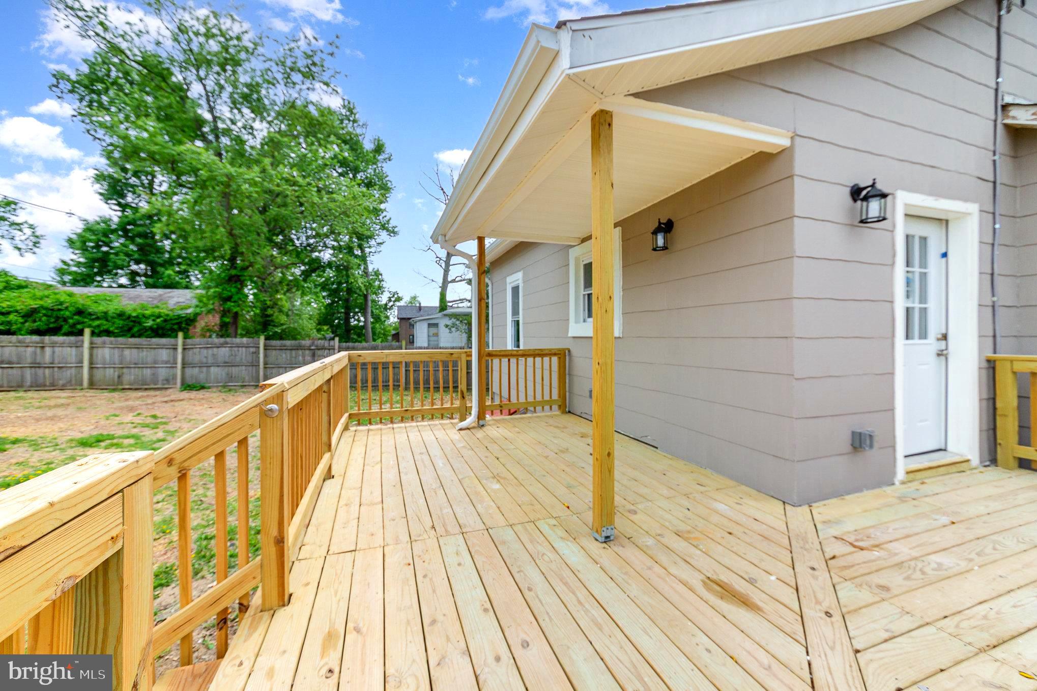 5611 Pilgrim Road Baltimore, MD 21214 - Photo 30 of 35 a view of balcony with wooden floor and fence