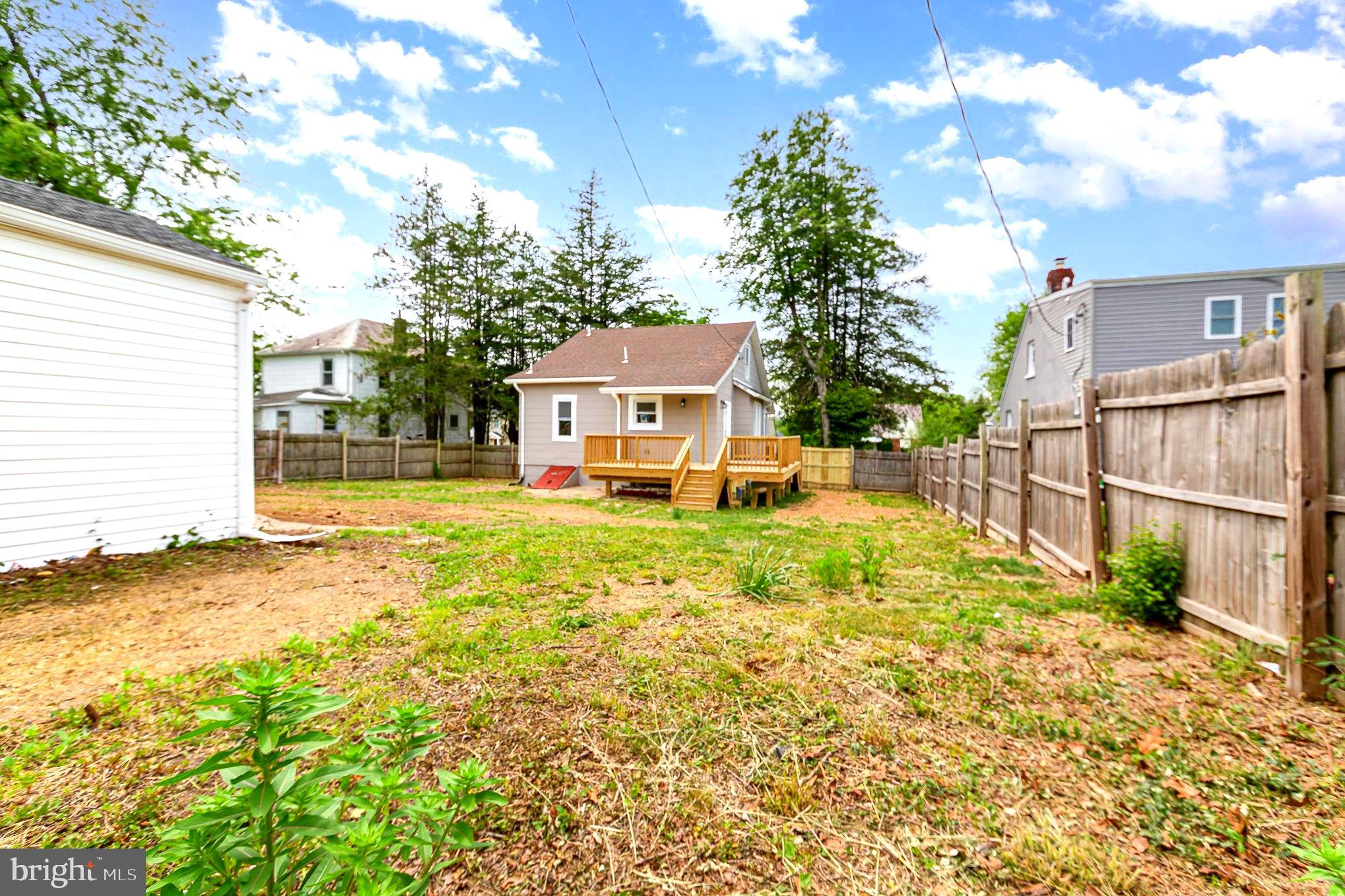 5611 Pilgrim Road Baltimore, MD 21214 - Photo 31 of 35 a view of a house with a small yard and large tree