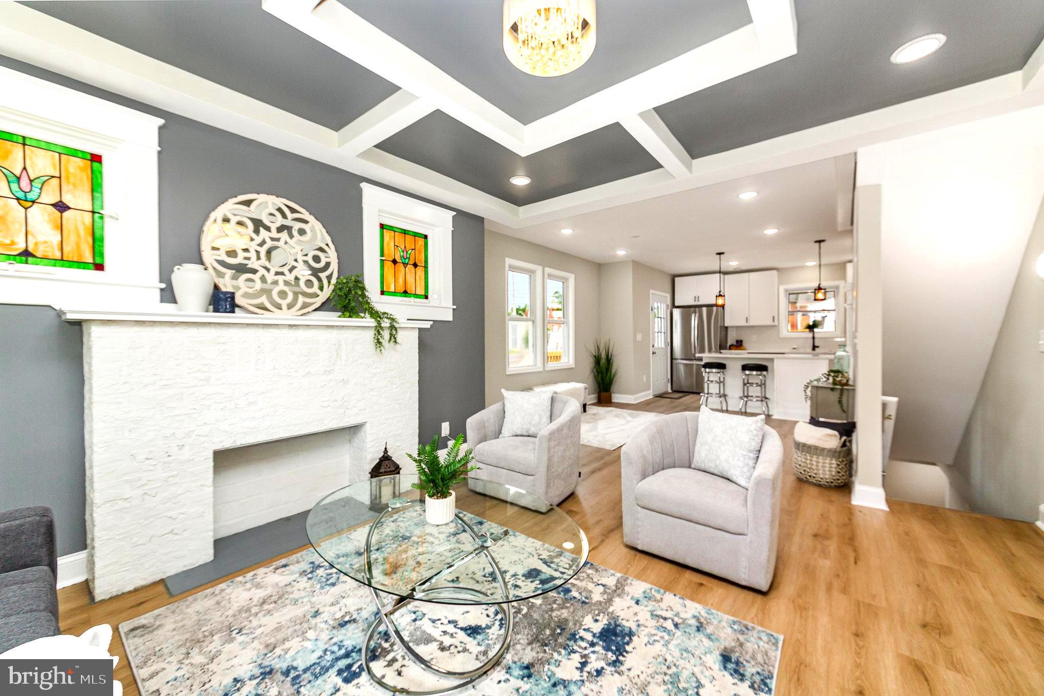 5611 Pilgrim Road Baltimore, MD 21214 - Photo 6 of 35 a living room with furniture and a fireplace