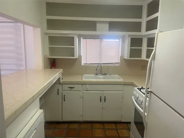 a bathroom with a sink toilet and a window